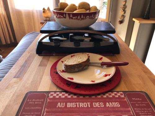 a plate of bread and a bowl of eggs on a table at Les Apparts de la Tourronde in Chorges