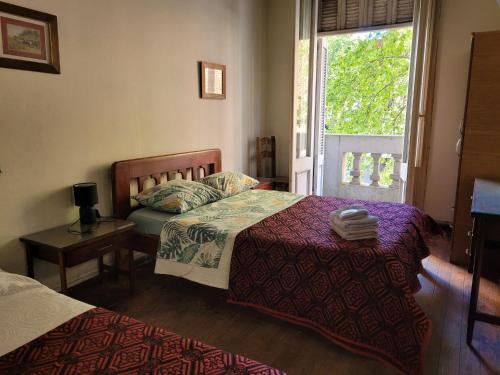 a bedroom with two beds and a window at Hotel Ateneo in Montevideo