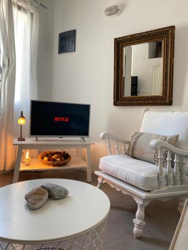 a living room with a tv and a couch at Pino di Loto Boutique Bed & Breakfast in Kini