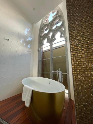 a large bath tub in a bathroom with a window at Martin's Dream Hotel in Mons