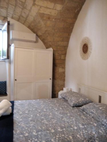 a bedroom with a bed and a white door at Gesuiti 25 in Bari