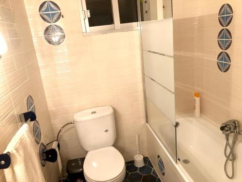a small bathroom with a toilet and a shower at 4 bedrooms villa with private pool enclosed garden and wifi at Olocau in Olocau