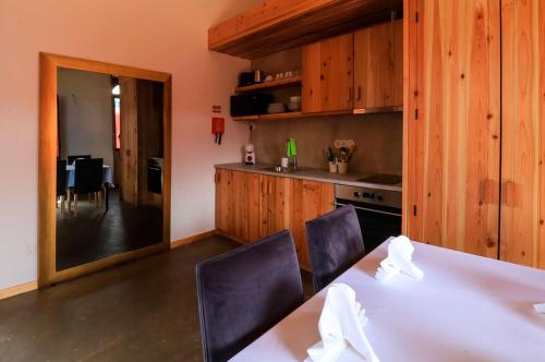 a kitchen with a table and chairs and a kitchen with a dining room at QUINTA DO FALCÃO in Almagreira