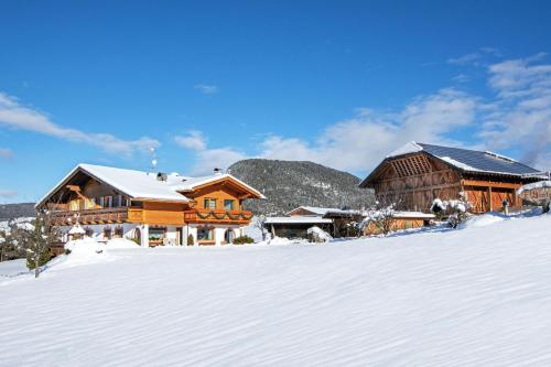 a log cabin in the snow with snow covered ground at Binterhof in Castelrotto