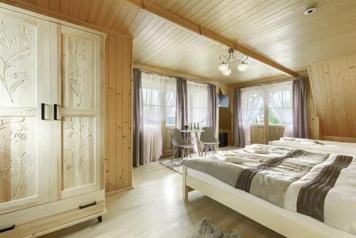 a bedroom with a large bed and wooden walls at Góralska rezydencja in Witów