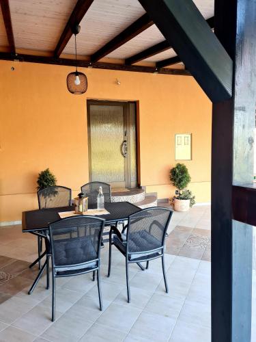 a patio with a table and chairs in a room at Kuća za odmor Primavera in Vinkovci