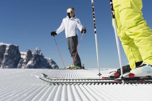 two people standing on skis in the snow at Binterhof in Castelrotto