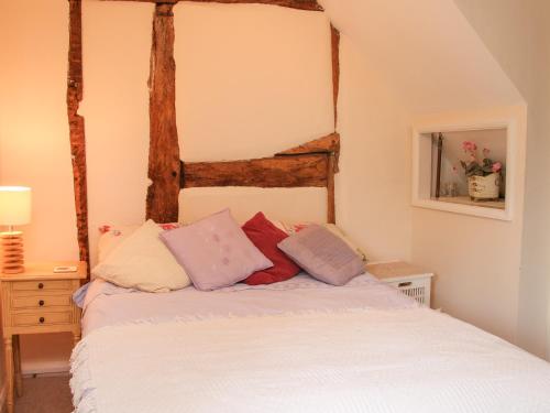 a bedroom with a bed with pillows on it at 55 Corve Street in Ludlow