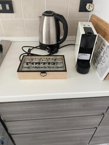 a kitchen counter with a coffee pot and a toaster at Residenza I Laghi in Porlezza