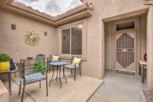 a patio with chairs and a table and a door at Pool and Spa Home on Golf Course in Surprise! in Surprise