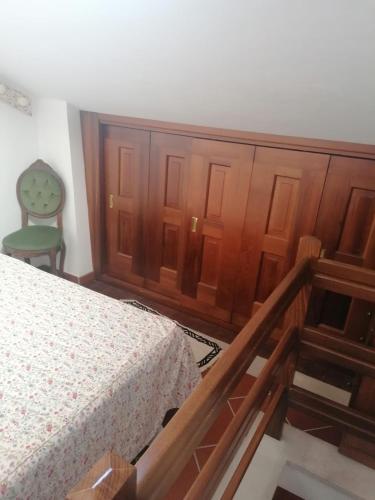 a bedroom with a bed and a wooden cabinet at Lo chalet Biancaneve in Picinisco