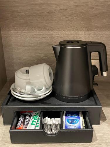 a tea pot sitting on top of a shelf at Byron Hotel in London