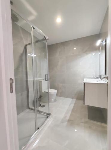 a bathroom with a shower and a sink and a toilet at Casa de Penedones - Ventos de Barroso in Penedones