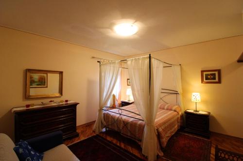 a bedroom with a bed with a canopy at Casale Lorenzo in Subbiano