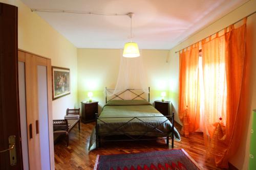 a bedroom with a bed in the middle of a room at Casale Lorenzo in Subbiano
