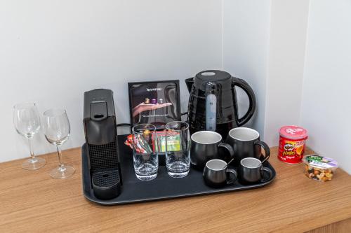 a tray with a coffee maker and glasses on a table at Hellenic Vibes Smart Hotel in Athens