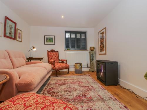 a living room with a couch and a fireplace at Frith Green in Bromyard