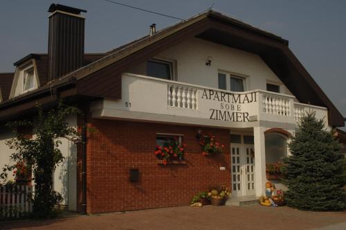 a building with a sign on the front of it at Apartments Sončnica in Moravske Toplice