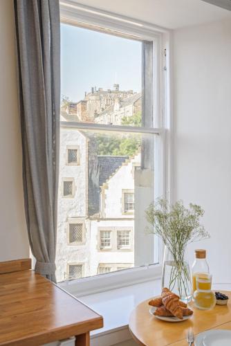 a window with a plate of food on a table at The West Bow View Apartment in Edinburgh