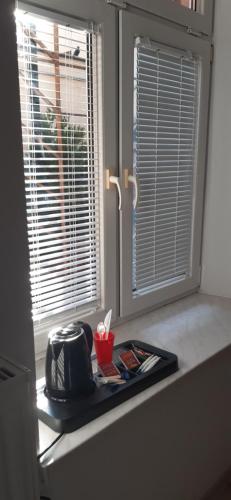 a kitchen counter with a window and a tray at Kraków Chilli Hostel in Kraków