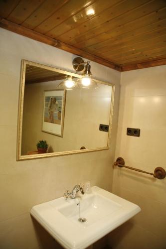 a bathroom with a sink and a mirror at HABITACIONES LAS TERMAS in Guadix