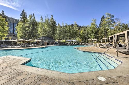 a large swimming pool with chairs and umbrellas at 6 Mi to Lake Tahoe Everline Resort Retreat! in Olympic Valley