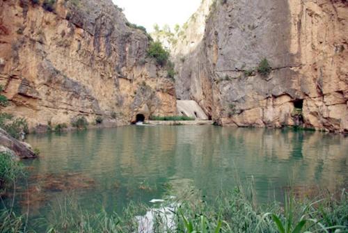 a river in a canyon with a tunnel in it at CASICA TIA CARMEN in Chulilla