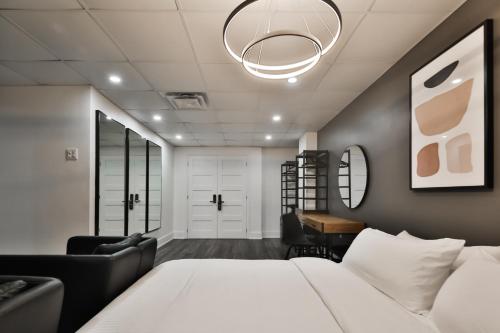 a bedroom with a bed and a desk and a chair at Hygie Boutique Hotel in Montreal