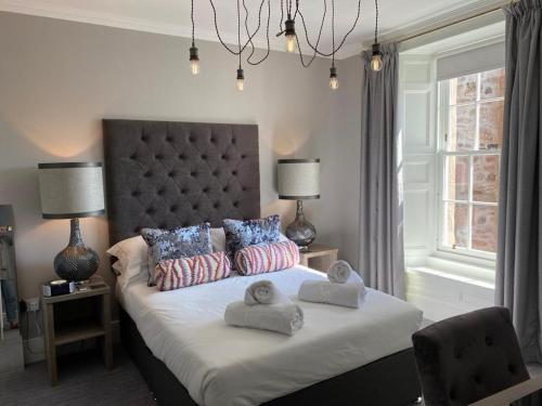 a bedroom with a bed with towels on it at No. 41 Town House in Inverness