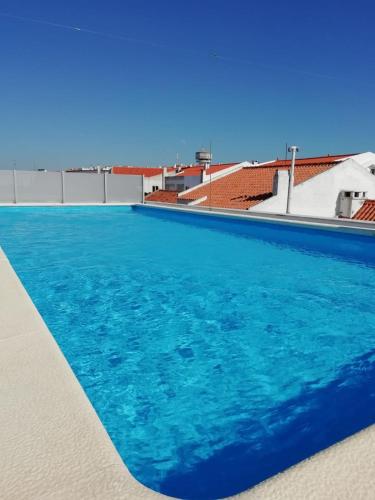 a swimming pool with blue water on top of a building at Varandas do Sítio - By SCH in Nazaré