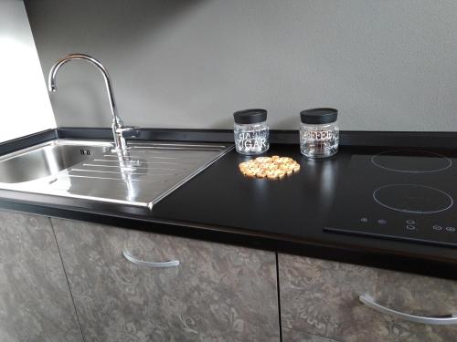 a kitchen counter with two glasses and a sink at Alpenrooms in Transacqua