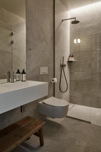 a bathroom with a sink and a toilet and a shower at RUNO Hotel Porvoo in Porvoo