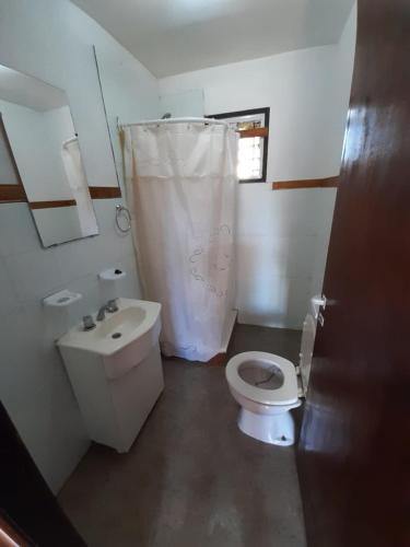 a small bathroom with a toilet and a sink at Cabañas Estrellas Doradas in Miramar