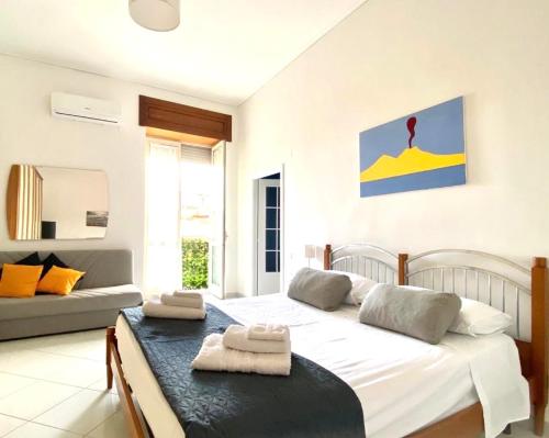 a bedroom with a large bed and a couch at Casa Luisa in Naples