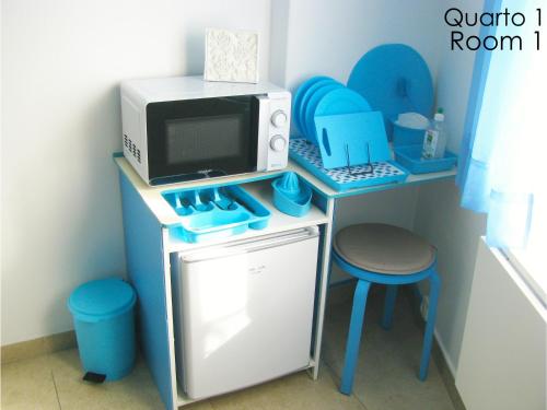 a toy kitchen with a microwave and a stove at Tiago & Jorge Guesthouse in Nazaré