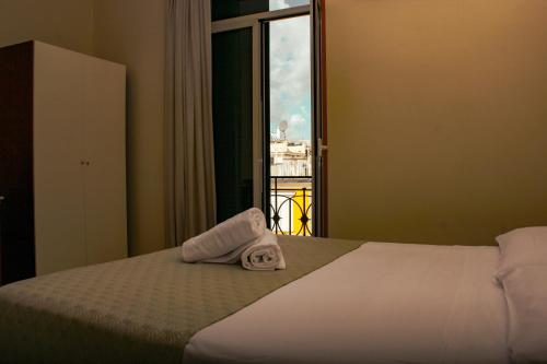 a hotel room with a bed with a towel on it at Hotel Garden Napoli in Naples