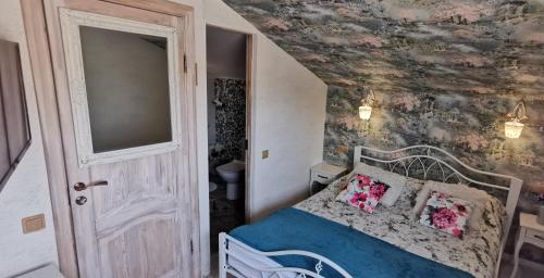 a bedroom with a bed in a room with a wall at Old Town Apartments in Jēkabpils