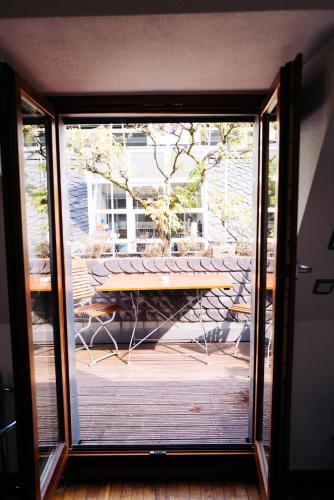 a view of a table through a sliding glass door at Lint Hotel Köln in Cologne