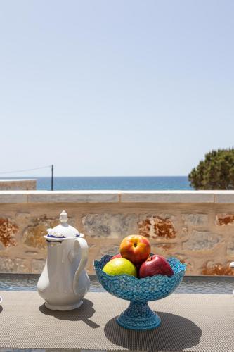 a bowl of fruit and a teapot on a table at Elaianthos 2 in Gythio