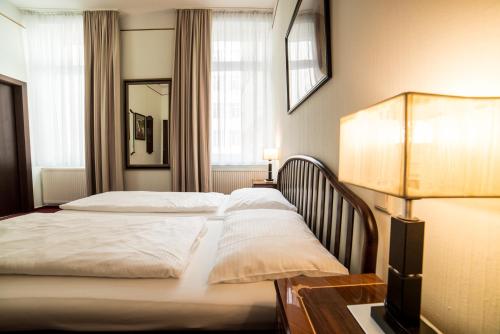 a hotel room with two beds and a lamp at Vienna Boutique - Premium Hostel in Vienna