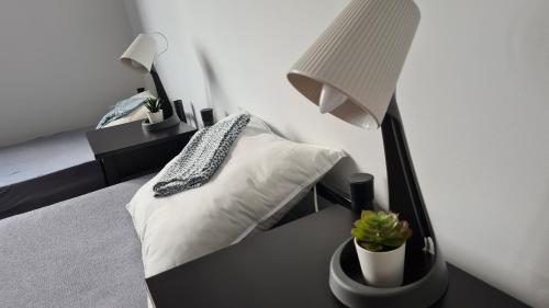 a bedroom with a bed with a desk with a lamp at Urocze Apartamenty na Wsi in Golędzinów