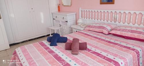 a girls bedroom with two beds and a dresser at Eldorado Luis 1bedroom ocean view in Playa de las Americas