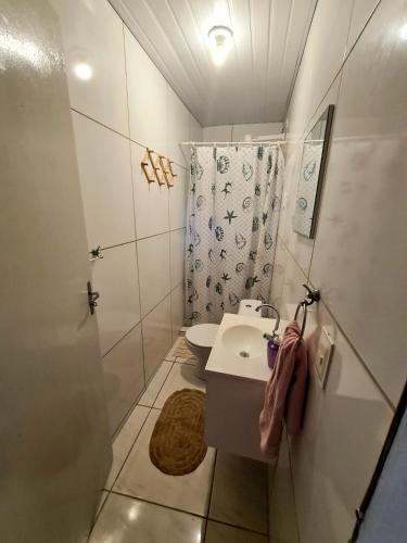 a small bathroom with a sink and a shower at Revive Guesthouse - Pé na areia in Maragogi
