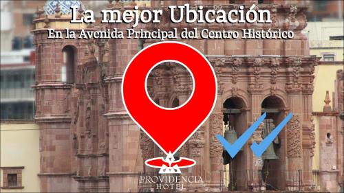 a poster with a red sign in front of a building at Hotel Providencia - Avenida Principal, Centro Histórico de Zacatecas in Zacatecas