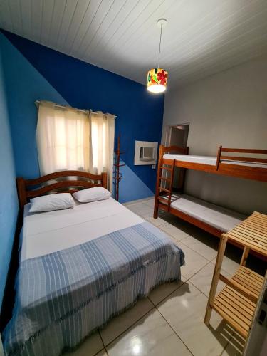 a bedroom with a bed and a bunk bed at Revive Guesthouse - Pé na areia in Maragogi