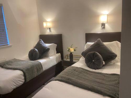 A bed or beds in a room at Bow Serviced Apartments