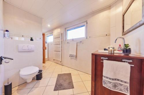 a bathroom with a toilet and a sink at Entspannung Pur in Herford