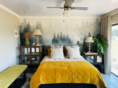 a bedroom with a yellow bed with a painting on the wall at Langalanga on the mountain bend in Tzaneen