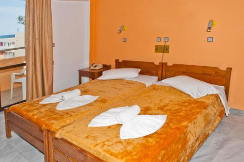 a bedroom with two beds with white towels on them at Thodorou Villa in Agia Marina Nea Kydonias