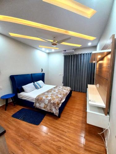 a bedroom with a bed and a ceiling fan at Bahria V&A Phase-2 in Rawalpindi